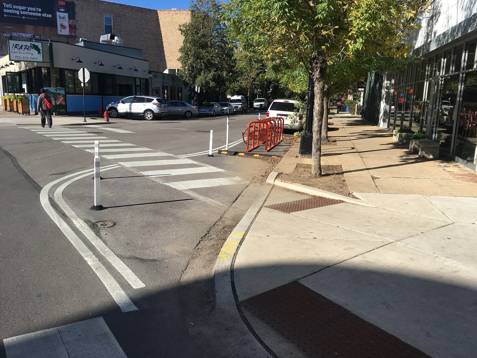 A bike corral beside a painted curb extension on a Chicago street