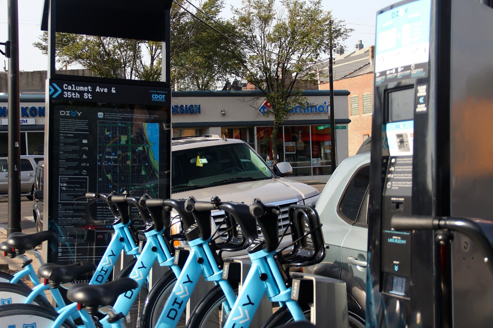 Row of blue Divvy classic bikes docked at the Calumet Ave and 35th St station in Chicago