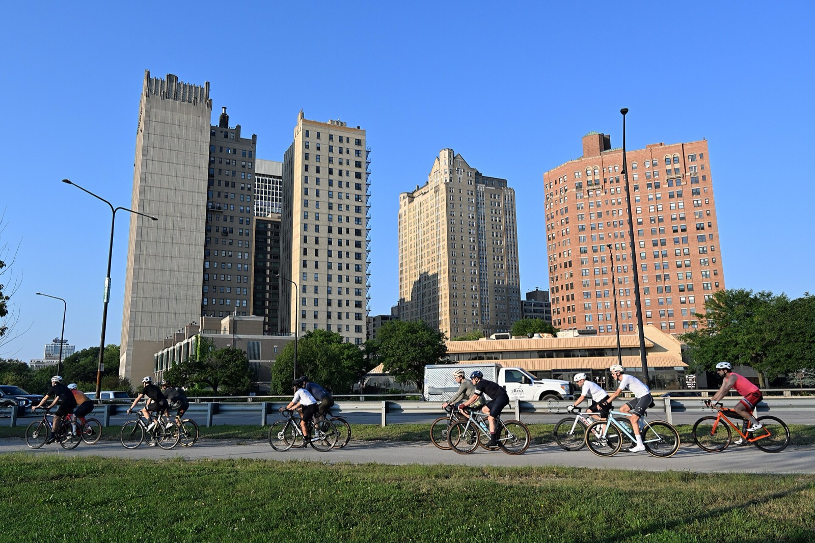 Cyclists riding the Lakefront Trail past Indian Village in Chicago