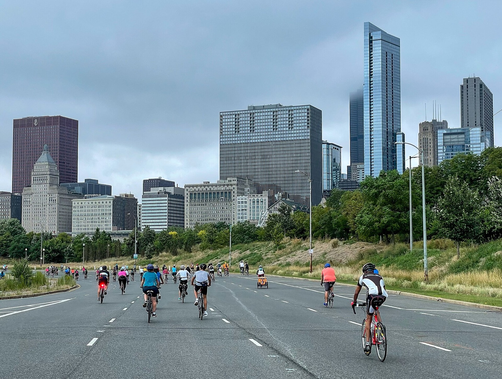 Riders on DuSable Lake Shore Drive with the downtown skyline behind them