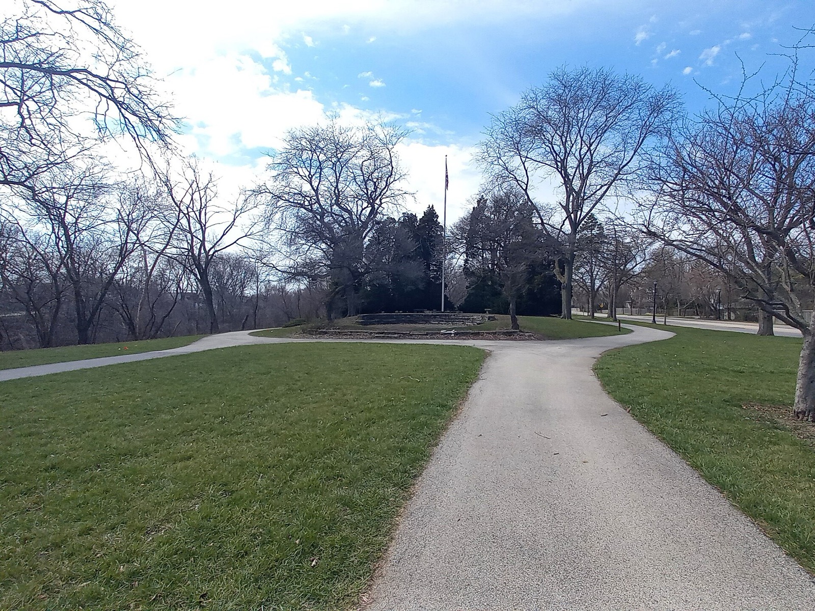 Paved path of the North Shore Channel Trail curving through lawn and bare trees
