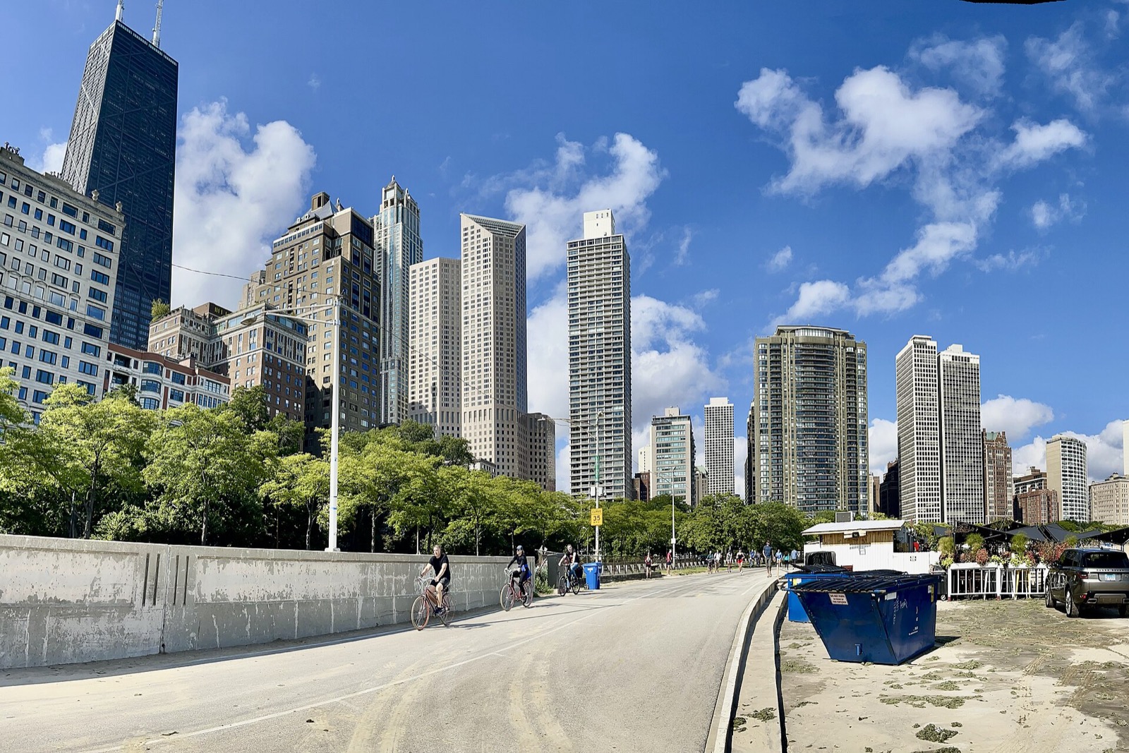 Cyclists on the Lakefront Trail beneath the Gold Coast towers on a clear September day
