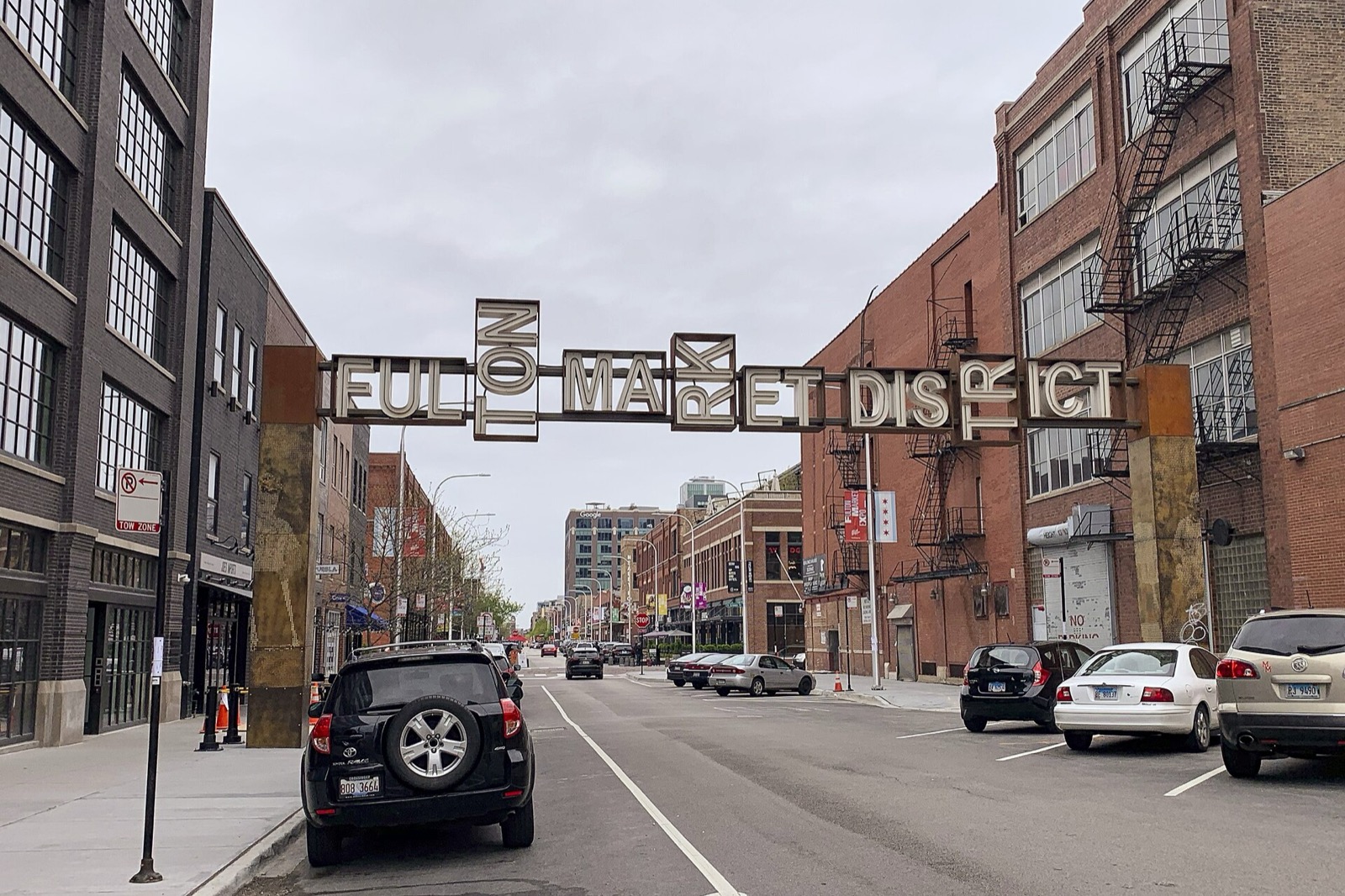 Fulton Market District arch sign over a brick street in Chicago