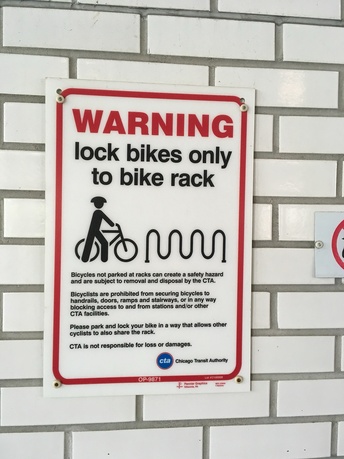 A CTA warning sign telling riders to lock bikes only to the bike rack
