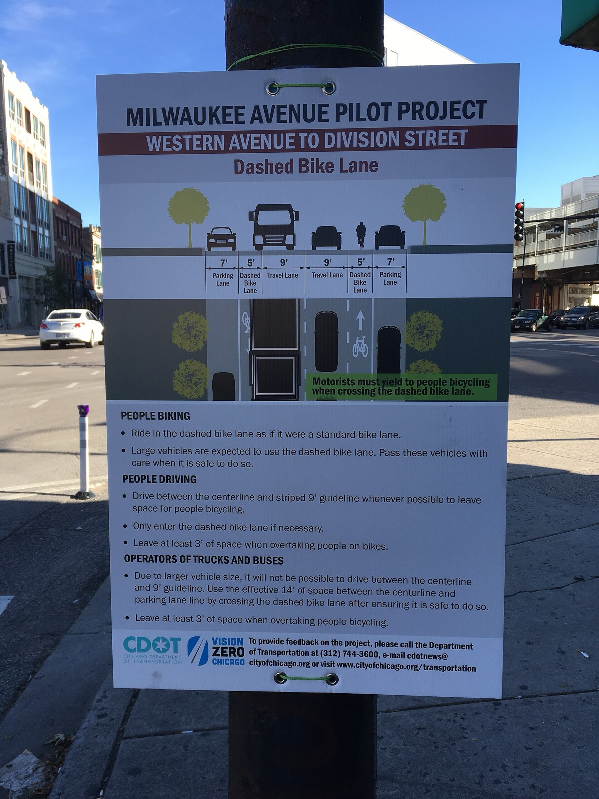A CDOT notice on a pole telling drivers to leave at least 3 feet when overtaking people on bikes